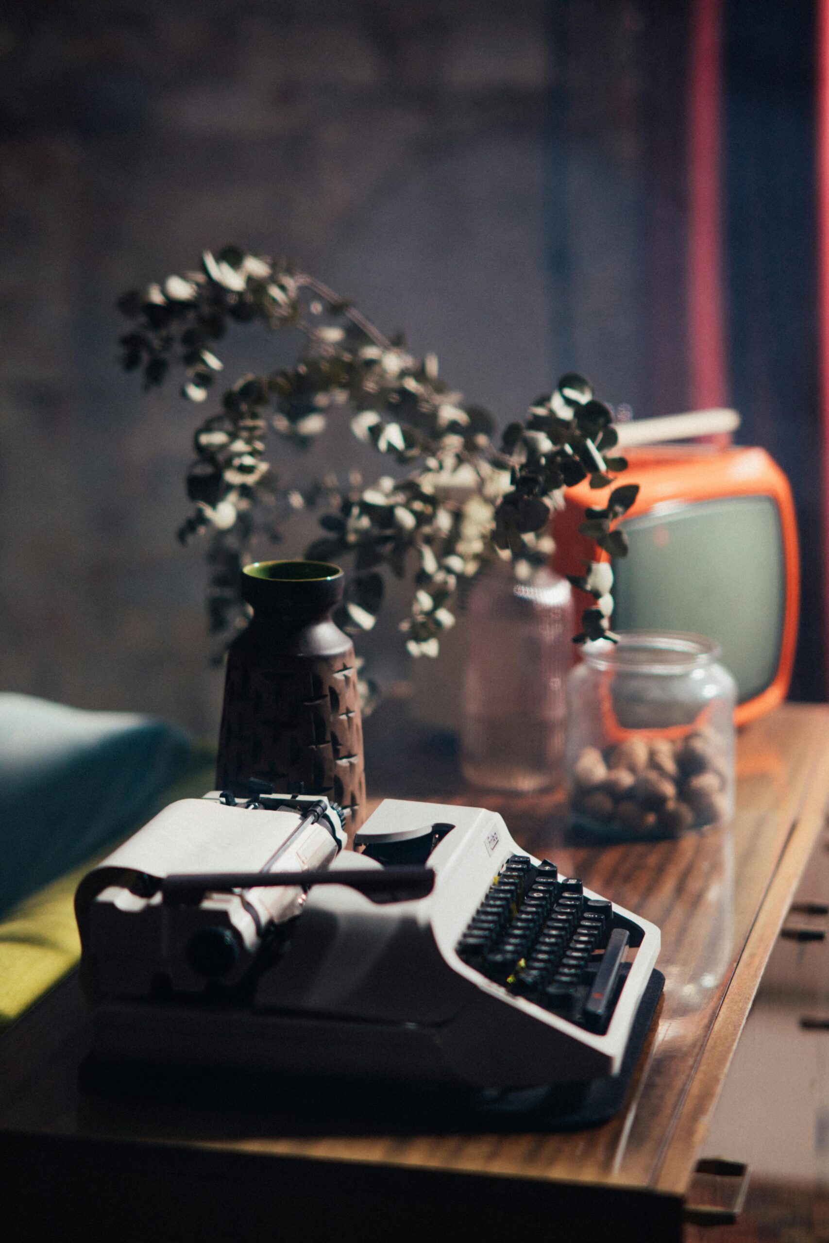 Classic still life with a vintage typewriter and retro decor on a wooden table.